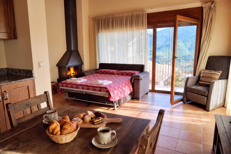 Apartament Rústic: sofà llit obert al costat de la llar de foc